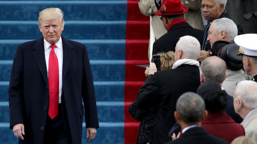 Trump on inauguration day Jan 20, 2017 wearing a dark overcoat and a red shiny satin tie that extends way past beyond the waistband pointing at his crotch - not very flattering
