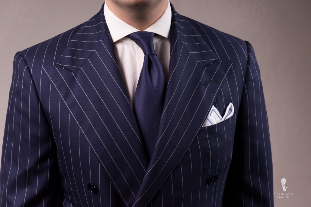 Chalk stripe suit with navy tie and White Irish Linen Embroidered Contrast Framing Pocket square