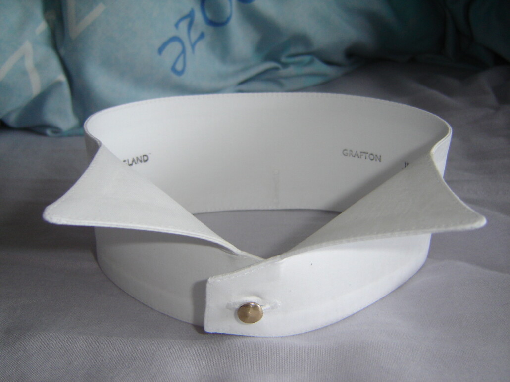 A stiff wing collar and stud, sitting on a table