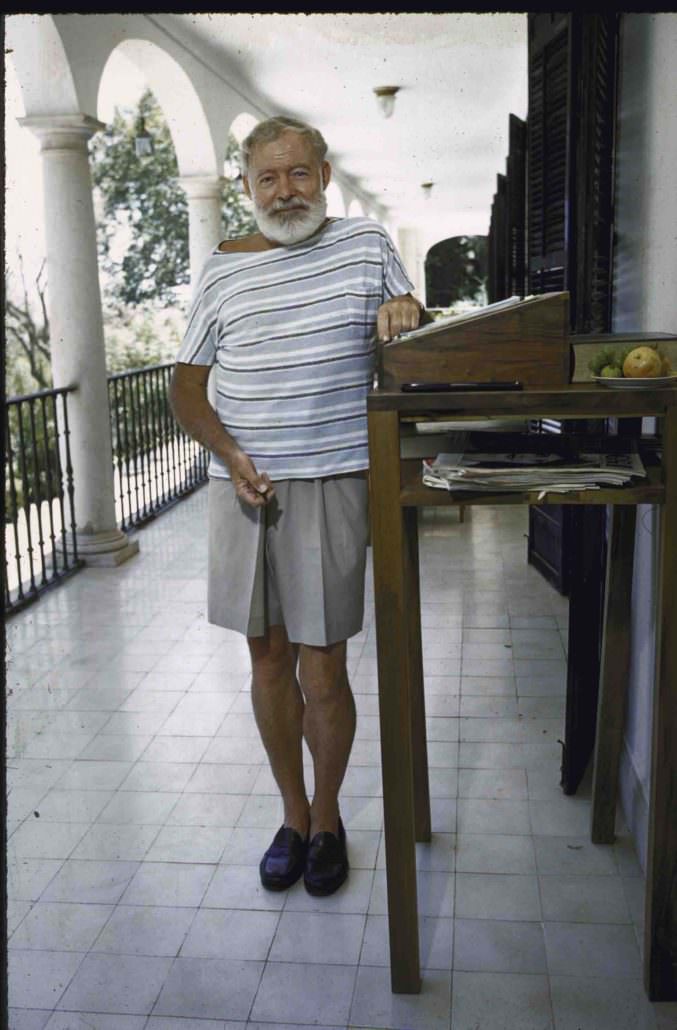 Ernest Hemingway in shorts at his standing desk