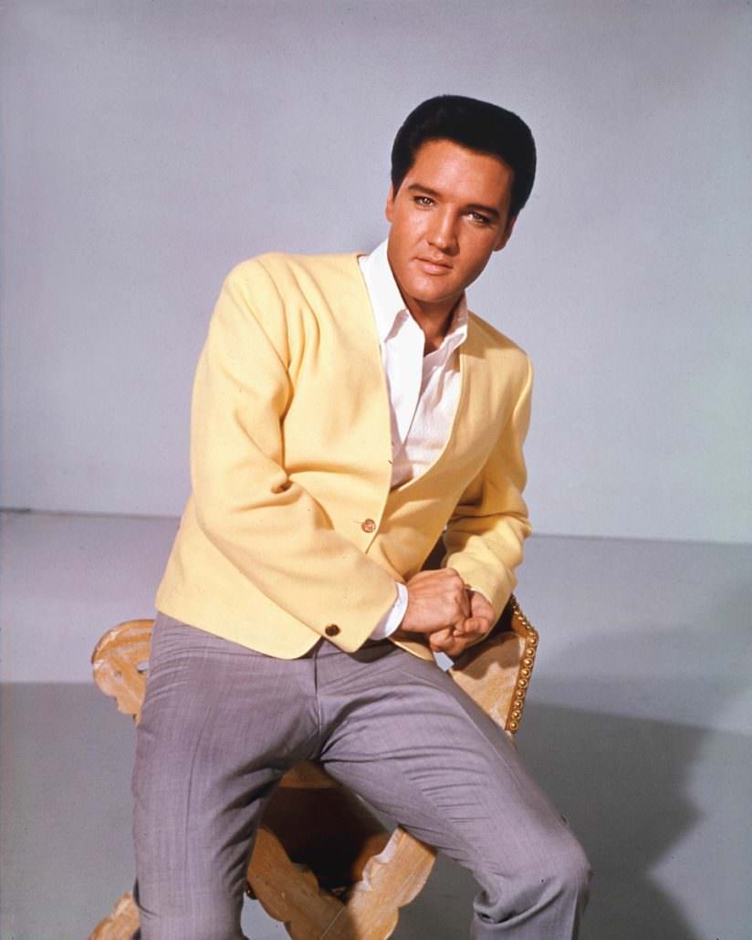 Elvis Presley wearing yellow jacket and gray pants