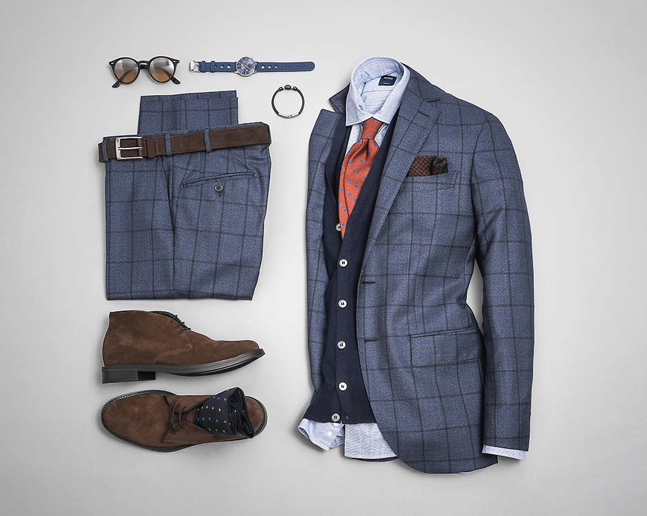This flat-lay image from Boggi Milano shows layering with shades of blue (light blue shirt, navy vest, admiral blue suit jacket).