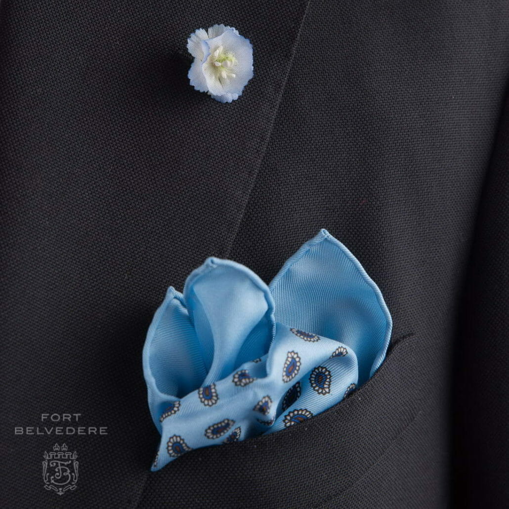 Light blue delphinium and pocket square on a navy blazer