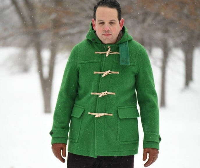 Sven wearing a bold green duffle coat