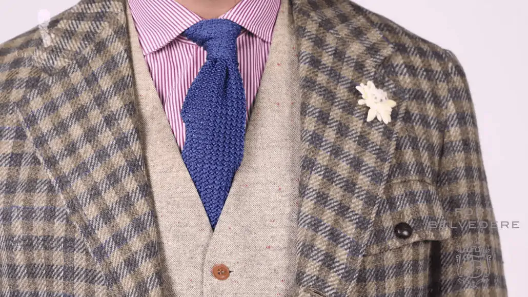 Tweed Jacket paired with a white and red striped shirt and a blue knit tie