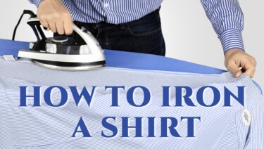 Ironing a blue and white striped shirt on a blue ironing board