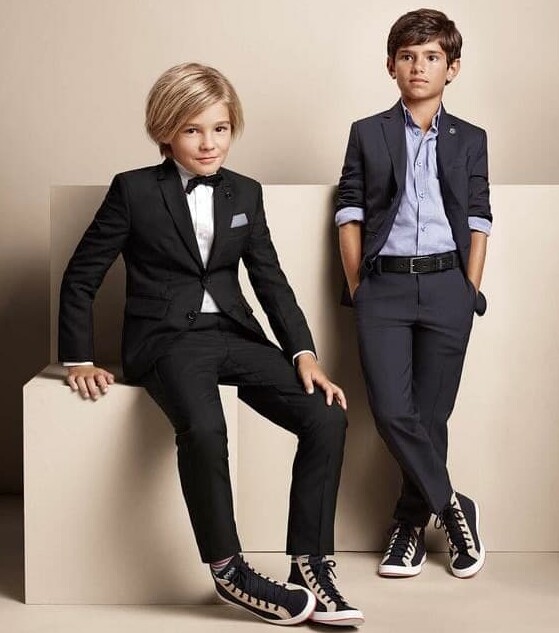 Let kids experiment with personal style without harsh judgment even if they want to wear sneakers with a suit. (Image Credit: Hugo Boss)