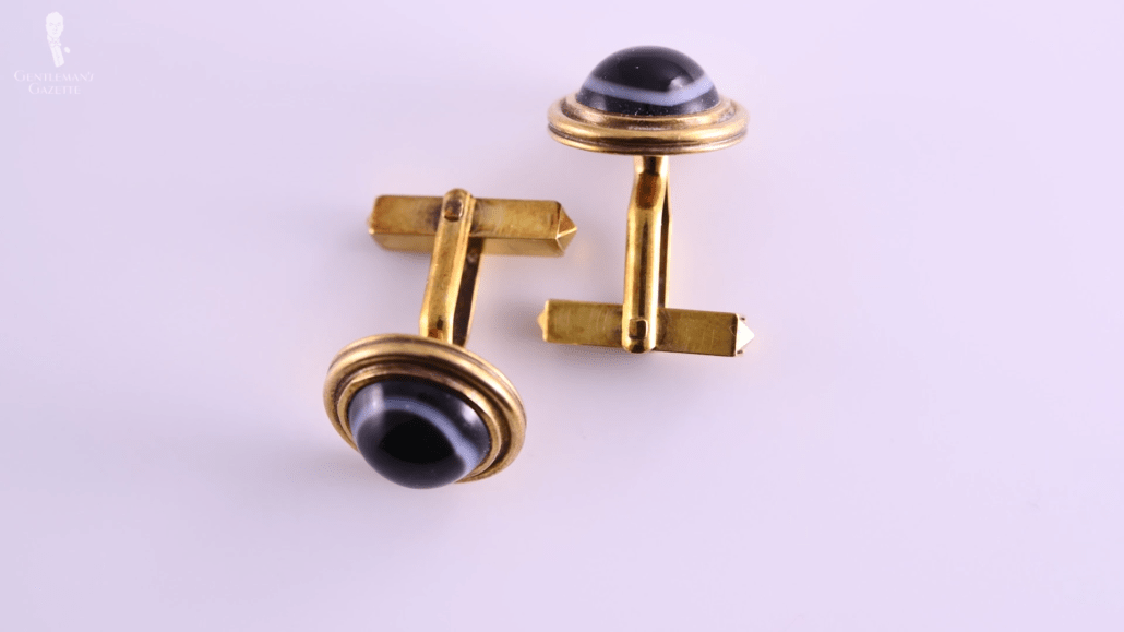 Black and white domed, round glass cufflinks in gold with t-bar