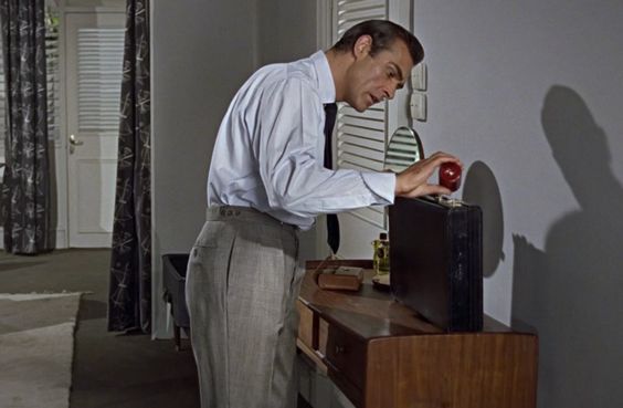 Sean Connery as James Bond, wearing trousers with vertical pockets.