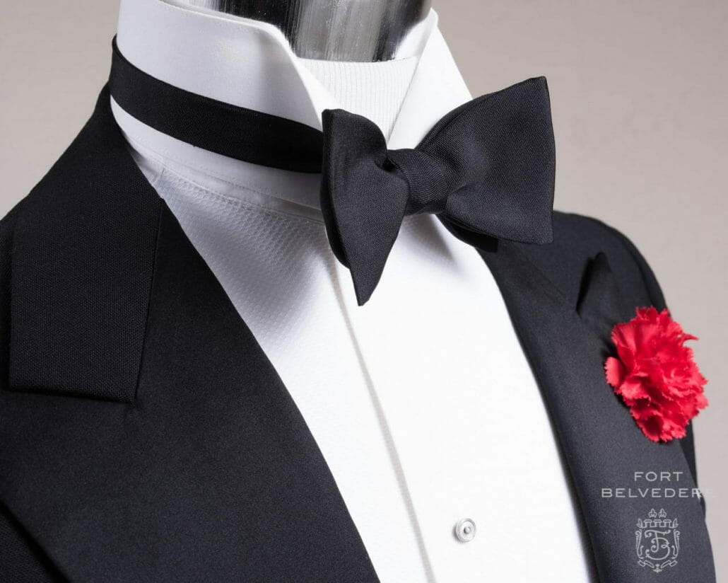 A mannequin in black tie ensemble with a Fort Belvedere barathea bow tie with a wing collar shirt.