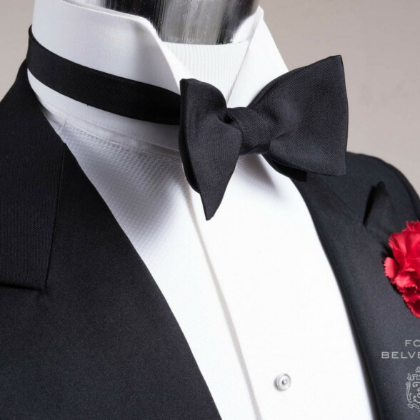 A mannequin in black tie ensemble with a Fort Belvedere barathea bow tie with a wing collar shirt.
