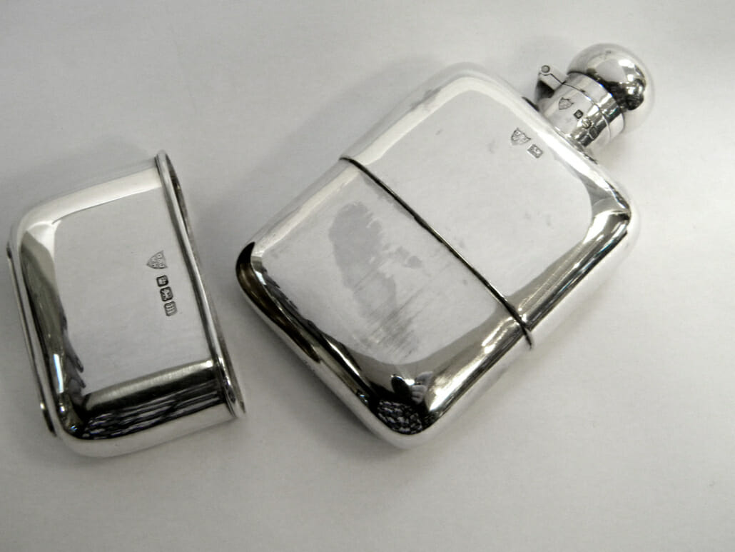  A vintage silver hip flask with a detachable bottom