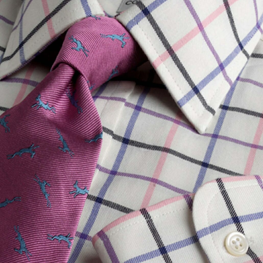 A tattersall shirt from Cordings incorporates pink purple, black and blue.