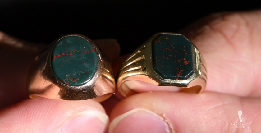 Unengraved signet rings in rose gold with oval bloodstone on the left and yellow gold cut bloodstone on the right