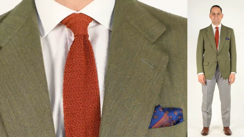 A single-breasted green suit jacket paired with a houndstooth pants that best suited for warm weather.