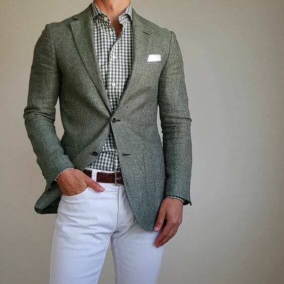Linus Norbom wearing a green linen jacket with a green and white gingham shirt and white pants
