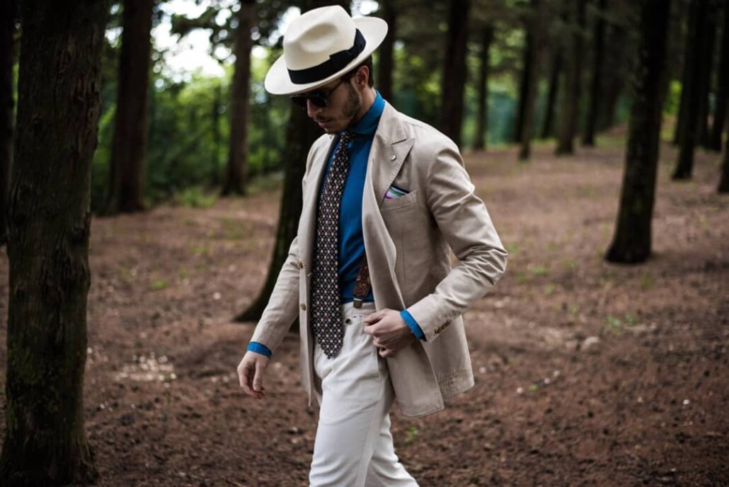 Panama hat, sand colored jacket, blue shirt, printed madder silk tie and off-white trouser