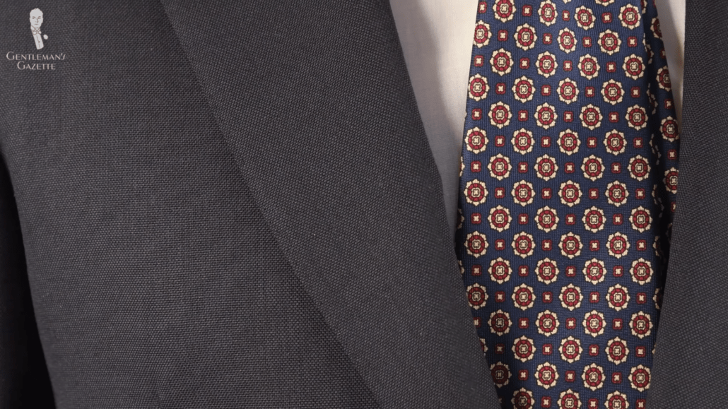 A dark suit with Fort Belvedere micropattern tie