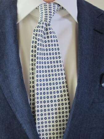 A white silk tie with geometric motif