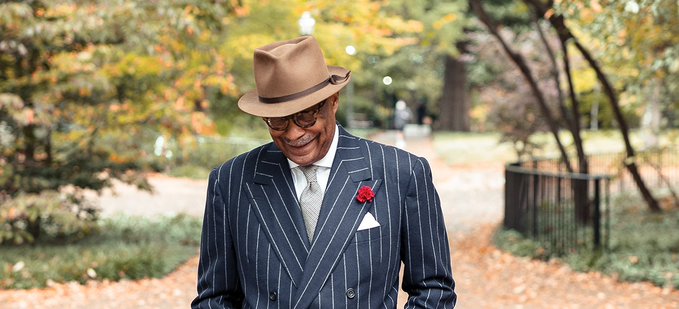 Dr. Andre Churchwell with Panama hat, and striped suit other accessories