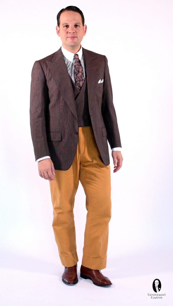 Raphael employing colorful spezzato with a suit jacket and matching vest with contrasting yellow pants and brown oxfords