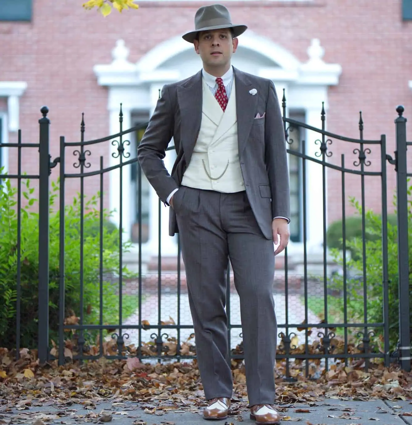Sven Raphael Schneider in a fall outfit consisting of fedora, vintage brown Caraceni suit, vest, winchester shirt, collar bar and spectators.