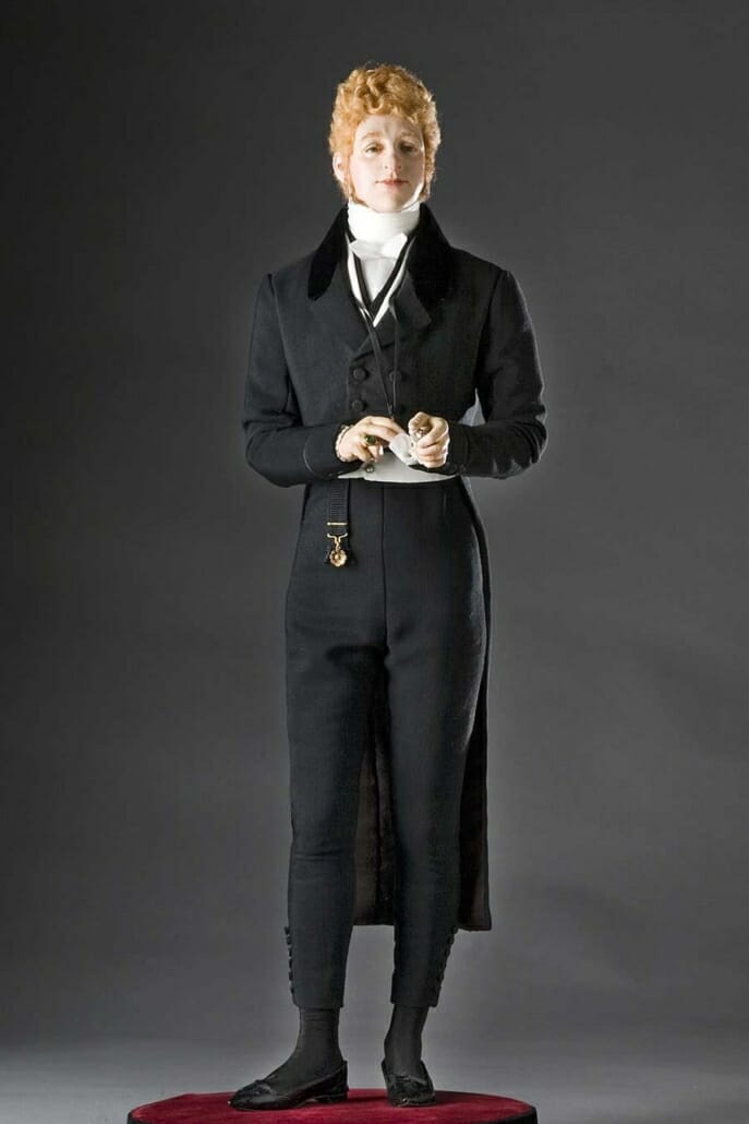 A Beau Brummell figurine, based on historical research, showing a closed tailcoat and white waistcoat.