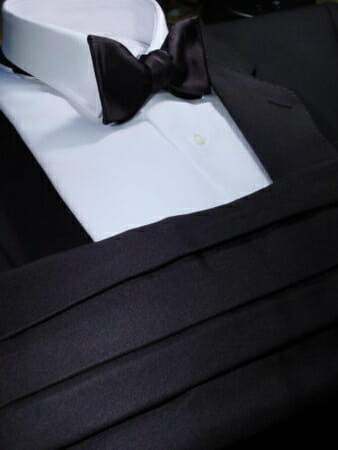 Silk barathea is used for the cummerbund, lapels and bow tie of this eminently tasteful British ensemble.