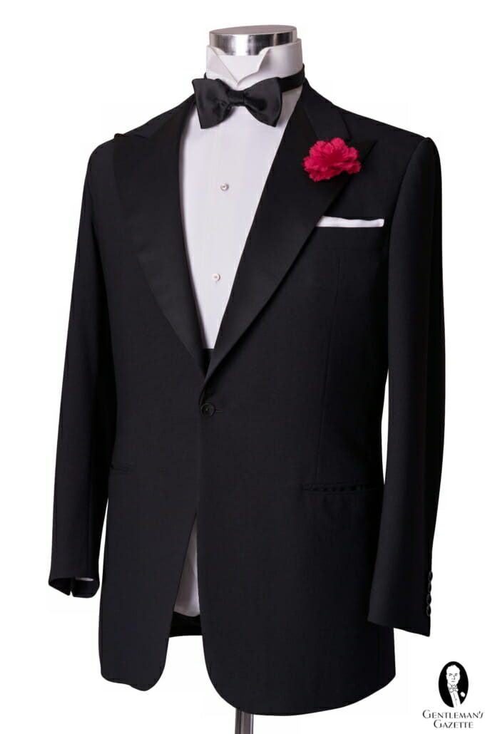 The most traditional model of tuxedo jacket: black and single-breasted with one closing button, peaked lapels with silk facings, and no rear vents.