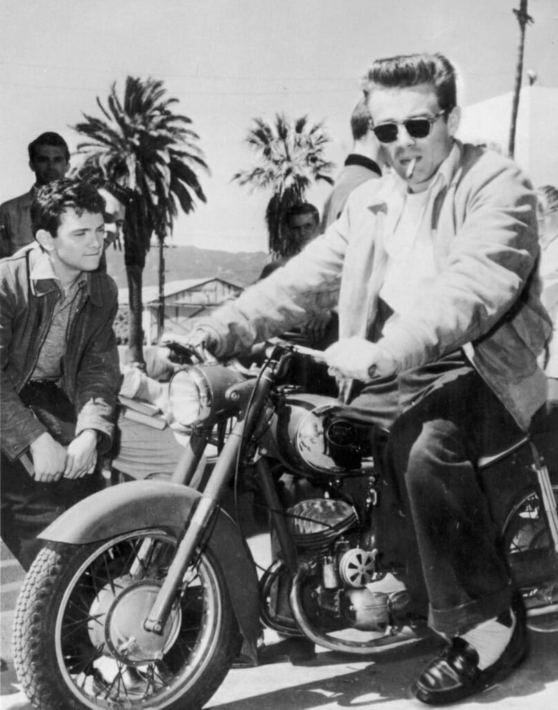 James Dean astride a motorcycle.