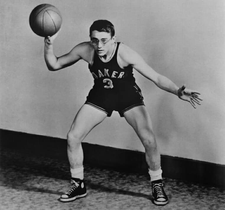 Dean poses in his Fairmount High Quakers basketball uniform, c. 1948