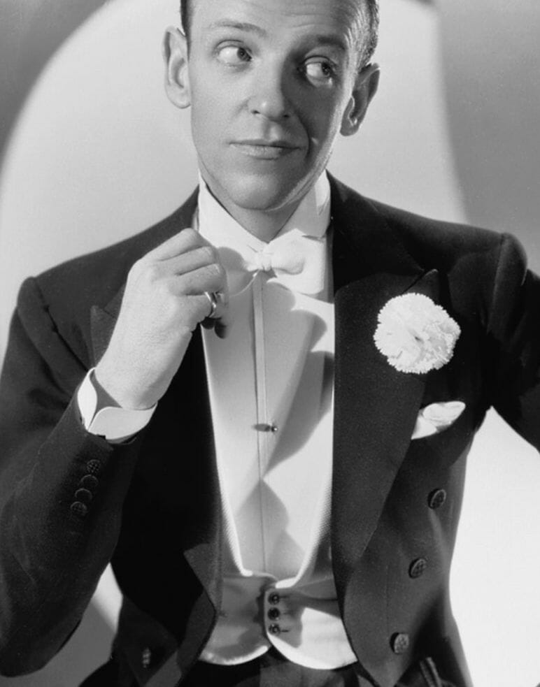 Fred Astaire circa 1936 wearing the popular white pearl shirt stud and the periods novel black waistcoat studs.