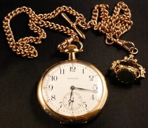 Gold Edwardian pocket watch with double Albert watch chain.