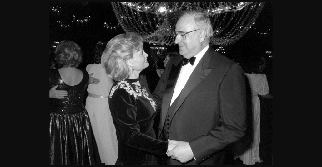 Helmut Kohl in 1987 wearing a peaked lapel tuxedo with pleated shirt front and evening waistcoat - note to pocket square or boutonniere