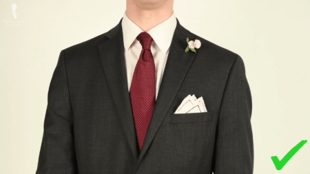 A charcoal suit with a red tie