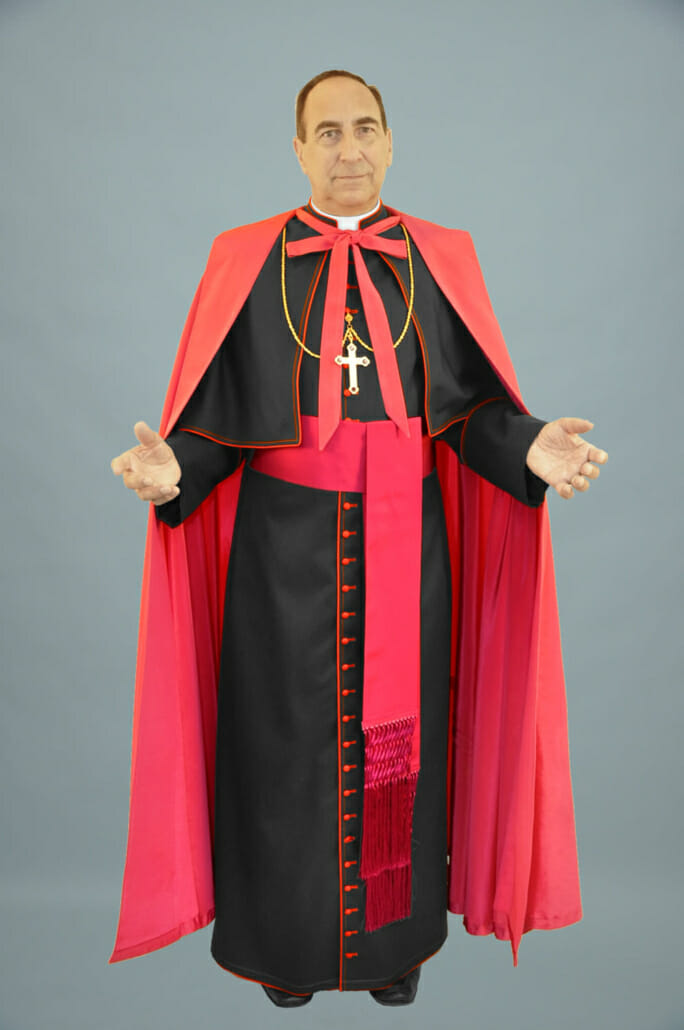 Catholic bishop wearing a traditional ferraiolone and cassock with a sash known as a band cincture or fascia