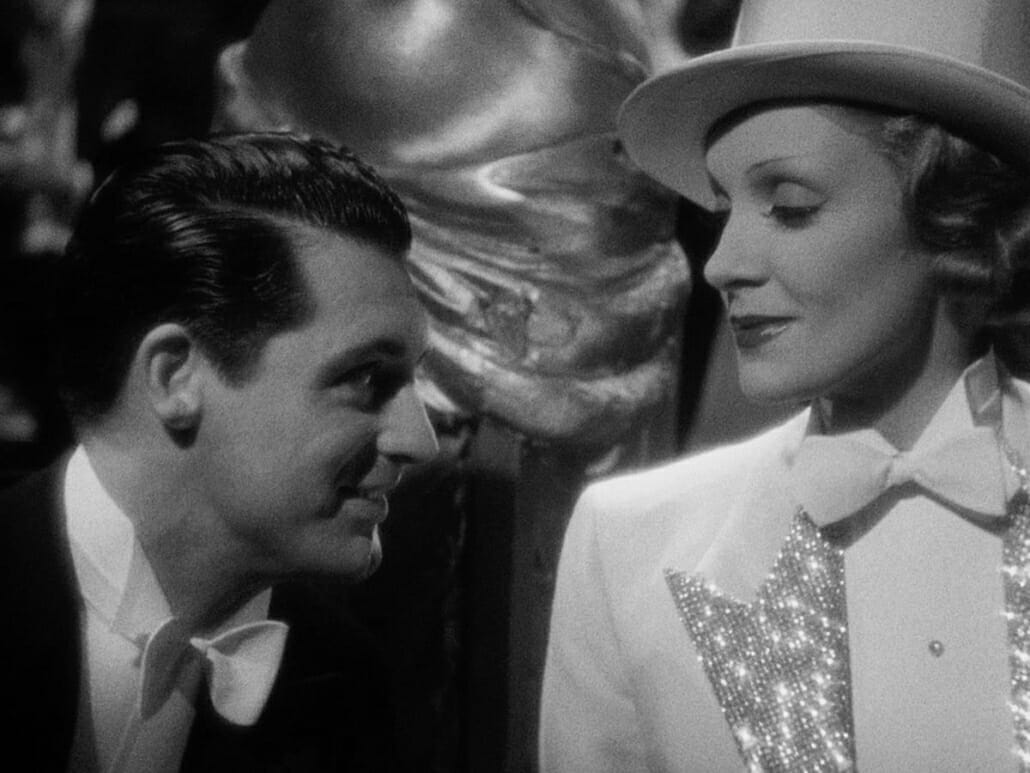 Dietrich in sparkly tailcoat wtih Cary Grant wearing a single end bow tie with his white tie ensemble