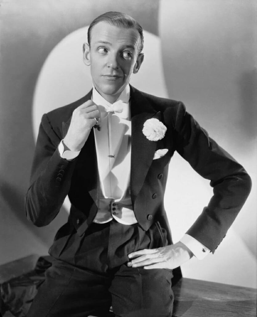 Fred Astaire in white tie - note the single pearl stud, large carnation boutonniere, basket weave covered silk buttons, rounded waiscoat tips with decorative buttons
