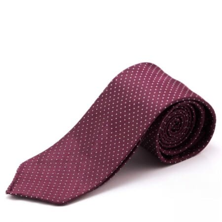 A photograph of a Silk Tie in Jacquard Burgundy Red with White Polka Dots