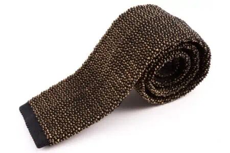 A knit tie made from charcoal and cognac yellow silk