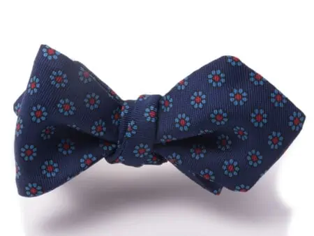 A photograph on a white background of a Subtle patterned Real Ancient Madder Silk Bow Tie by Fort Belvedere