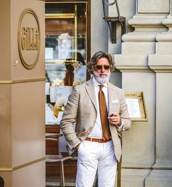 Franco Mazzetti showing how to use a belt to divide a white shirt and pants combination