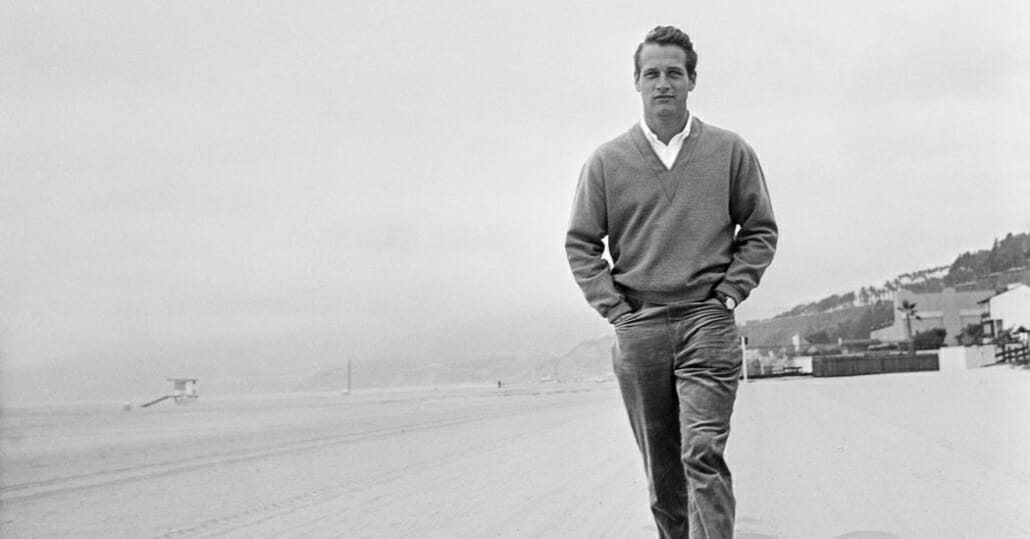 Paul Newman on the beach layering with a V-neck