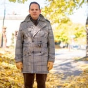 Sven Raphael Schneider wearing a vintage double-breasted check plaid overcoat with an Alpaca double-sided scarf and leather gloves