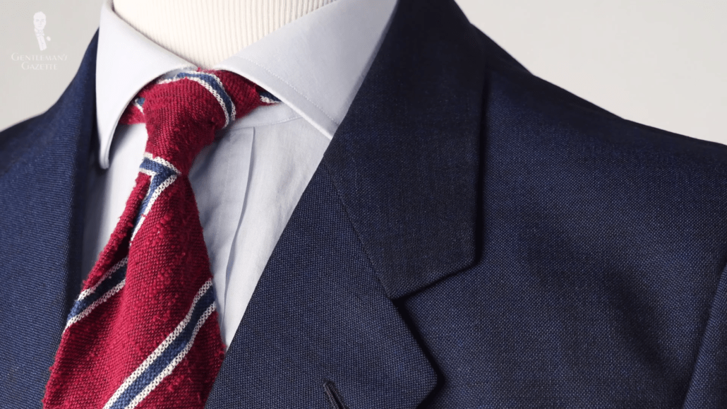 A blue jacket, pale blue shirt, and shantung striped tie in red, blue, and white
