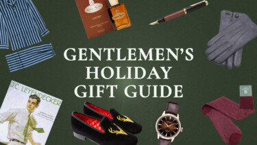 A selection of gentlemen's gifts, such as a book on J.C. Leyendecker, a Seiko watch, and Fort Belvedere silk socks, surrounding central text reading, "Gentlemen's Holiday Gift Guide"