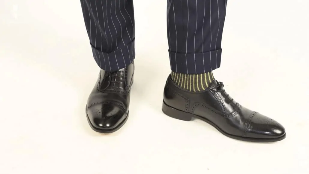Striped navy suits are best paired with black oxfords (Pictured: Navy and Yellow Shadow Stripe Ribbed Socks from Fort Belvedere)