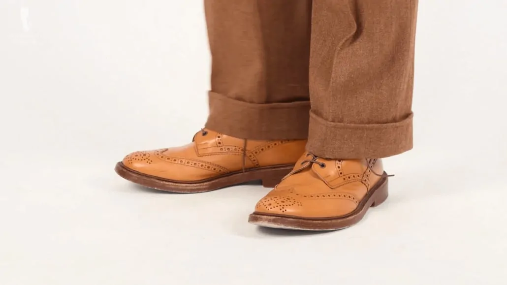 Tan double soled boots from Trickers worn with brown herringbone suit