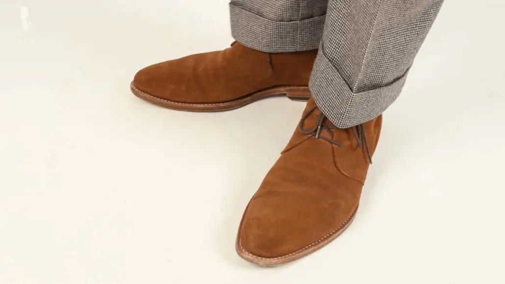 Mid brown suede chukka boots with a houndstooth suit