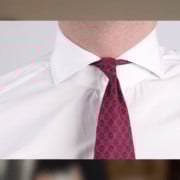 Screen Shot 2020 03 20 At 11.44.03 Am While the Madder Silk Tie in Dark Ruby Red Macclesfield Neats Blue Orange Pattern from Fort Belvedere is attractive, it’s also thin–and the use of a small knot leaves too much of the neckband exposed with this spread collar